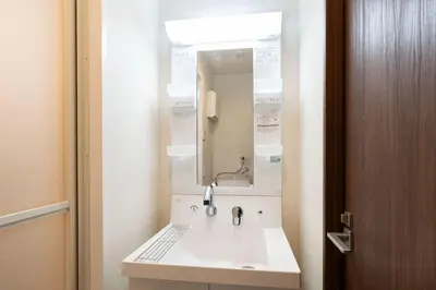 a bathroom with a sink and a mirror at \u30e9\u30a6\u30ec\u30a2\u30bf\u30ef\u30fc\u6c60\u888b in Tokyo