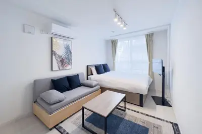 a small bedroom with a bed and a couch at toggle BUNKYO KORAKUEN in Tokyo