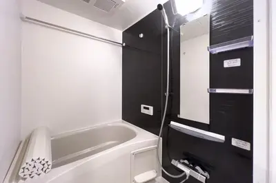 a small bathroom with a tub and a sink at toggle BUNKYO KORAKUEN in Tokyo