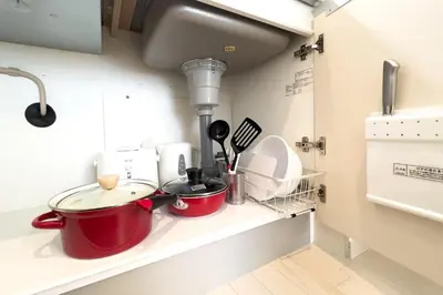 a kitchen counter with pots and pans on a shelf at toggle BUNKYO KORAKUEN in Tokyo