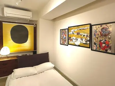 a bedroom with four paintings on the wall at \u4e0a\u91ce\u6d45\u8349\u9280\u5ea7\u8fd1\u3044 \u5c71\u624b\u7dda\u5fa1\u5f92\u753a\u99c53\u5206 \u30a2\u30e1\u6a2a3\u5206 \u4e0a\u91ce\u99c510\u5206 \u4e0a\u91ce\u5e83\u5c0f\u8def\u99c53\u5206 \u6e6f\u5cf6\u99c52\u5206 2-4\u4eba \u30ec\u30c8\u30ed\u548c\u98a8\u7573\u5bdd\u5ba4 in Tokyo