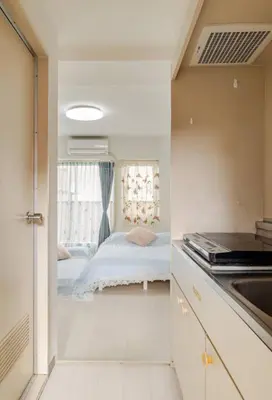 a small kitchen with a bed and a window at \u6da9\u8c37\u4e2d\u5fc3 ! \u6da9\u8c37\u5341\u5b57\u8def\u53e3 109 Shibuya scramble crossing \u9ad8\u901f\u65e0\u9650\u5236\u7f51\u7edc#703 in Tokyo