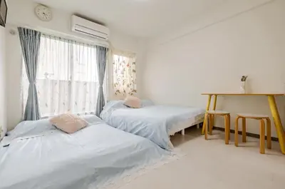 two beds in a room with a window at \u6da9\u8c37\u4e2d\u5fc3 ! \u6da9\u8c37\u5341\u5b57\u8def\u53e3 109 Shibuya scramble crossing \u9ad8\u901f\u65e0\u9650\u5236\u7f51\u7edc#703 in Tokyo