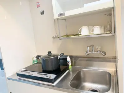 a kitchen with a sink and a pot on a stove at \u6da9\u8c37\u4e2d\u5fc3 ! \u6da9\u8c37\u5341\u5b57\u8def\u53e3 109 Shibuya scramble crossing \u9ad8\u901f\u65e0\u9650\u5236\u7f51\u7edc#703 in Tokyo
