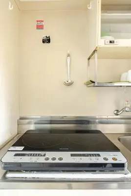 a kitchen with a stove top in a kitchen at \u6da9\u8c37\u4e2d\u5fc3 ! \u6da9\u8c37\u5341\u5b57\u8def\u53e3 109 Shibuya scramble crossing \u9ad8\u901f\u65e0\u9650\u5236\u7f51\u7edc#703 in Tokyo