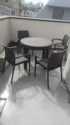a table and chairs and a table and chairs on a roof at Hananosato Hotel \u6c60\u888b\u672c\u5e97 in Tokyo