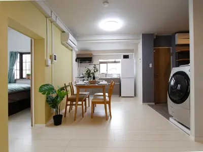 a kitchen and dining room with a table and chairs at \u6e21\u9089\u30d3\u30eb in Tokyo