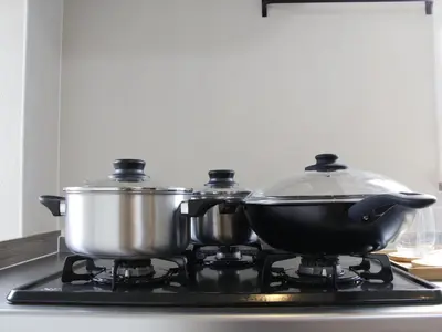 two pots and pans on a stove in a kitchen at \u6e21\u9089\u30d3\u30eb in Tokyo