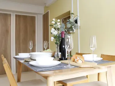 a dining room table with glasses and white dishes on it at \u6e21\u9089\u30d3\u30eb in Tokyo