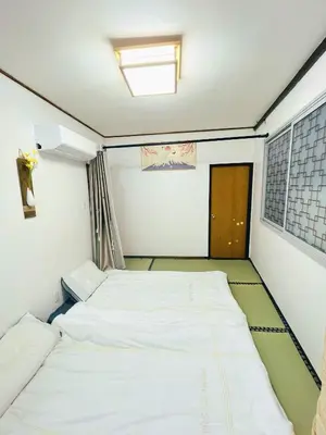 a small room with two beds in it at Momo House Near Komagome easy to shinjuku, Ueno, Tokyo in Tokyo