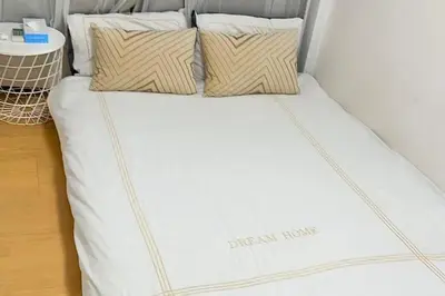 a bed with two pillows on top of it at Momo House Near Komagome easy to shinjuku, Ueno, Tokyo in Tokyo