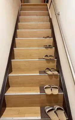 a set of stairs with pairs of shoes on them at Momo House Near Komagome easy to shinjuku, Ueno, Tokyo in Tokyo