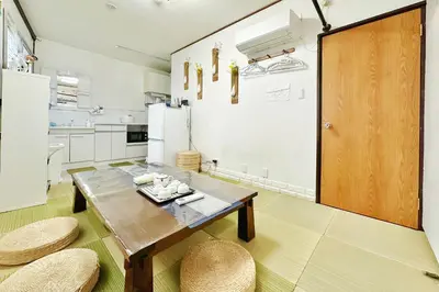 a kitchen with a wooden table and two chairs at Momo House Near Komagome easy to shinjuku, Ueno, Tokyo in Tokyo
