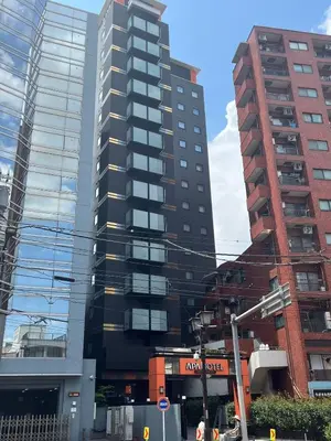 a tall black building in a city with buildings at Momo House Near Komagome easy to shinjuku, Ueno, Tokyo in Tokyo
