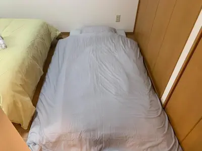 a small bed in a small room with at Compact 2DK in west Shinjuku in Tokyo
