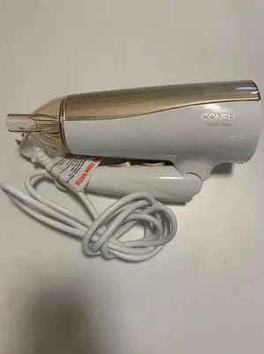 a hair dryer with a cord hooked up to it at Compact 2DK in west Shinjuku in Tokyo