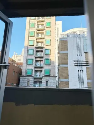 a view of a tall building from a window at Shinjuku Center\u65b0\u5bbf\u4e2d\u5fc3! 3min walk from subway\u6700\u8fd1\u5730\u94c1\u7ad93\u5206! Shinjuku Kabukicho\u65b0\u5bbf\u6b4c\u821e\u4f0e! \u8457\u540d\u8fde\u9501\u5927\u578b\u516c\u5bd3!314 in Tokyo