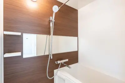 a shower in a bathroom with a wooden wall at Felice\u68ee\u4e0b in Tokyo