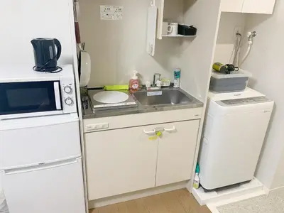 a small kitchen with a sink and a microwave at JR t akadababa subway 5 mins walk! Newly building \u65b0\u7bc9! \u9ad8\u7530\u99ac\u5834\u99c5 \u5f92\u6b69\u570f\u5185\u5927\u4eba\u6c17! Shinjuku\u65b0\u5bbf\u5708!\u9ad8\u901f\u65e0\u9650\u5236Wi-FI! B2 in Tokyo