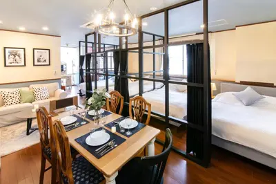 a room with a dining table and a bed at 【5/24NEW OPEN】浅草徒歩3分/Max9名/無料駐車場/渋谷直通 in Tokyo
