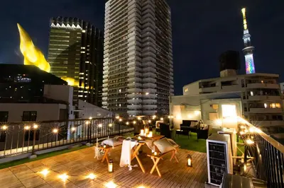 a rooftop deck with a view of a city at night at 【5/24NEW OPEN】浅草徒歩3分/Max9名/無料駐車場/渋谷直通 in Tokyo