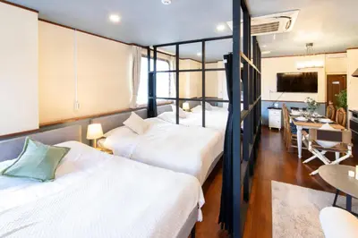 a room with four bunk beds and a dining room at 【5/24NEW OPEN】浅草徒歩3分/Max9名/無料駐車場/渋谷直通 in Tokyo
