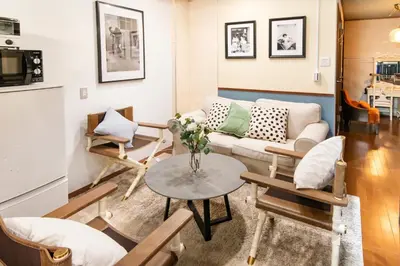 a living room with a couch and a table at 【5/24NEW OPEN】浅草徒歩3分/Max9名/無料駐車場/渋谷直通 in Tokyo