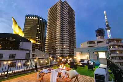 a balcony with a table and chairs on a building at 【5/24NEW OPEN】浅草徒歩3分/Max9名/無料駐車場/渋谷直通 in Tokyo