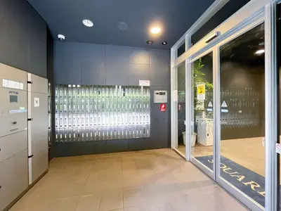 an empty hallway of a building with a glass door at ANGO Shibuya I in Tokyo