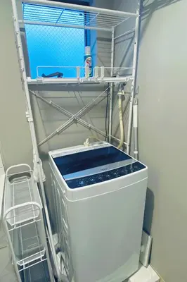 a washing machine in a room with a shelf at Tokyo Asakusa New Condo Sensoji-6min in Tokyo