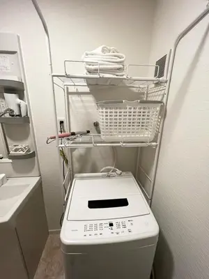 a bathroom with a toilet with a basket on top of it at \u30a2\u30f3\u30c9\u30b9\u30c6\u30a4\u4e0a\u9ad8\u75302\u4e01\u76ee in Tokyo