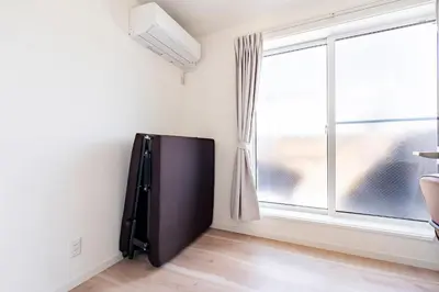 a black refrigerator in a room with a window at \u30a2\u30f3\u30c9\u30b9\u30c6\u30a4\u4e0a\u9ad8\u75302\u4e01\u76ee in Tokyo