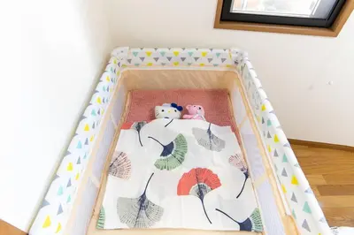 a baby crib with two stuffed animals in it at Elle's Shirokane Guest house 301 in Tokyo
