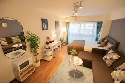 a living room with a bed and a mirror at New Design Apartment in Shinjuku Kabukicho! 3 mins station in Tokyo