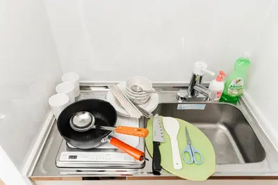 a kitchen sink with a frying pan and utensils at New Design Apartment in Shinjuku Kabukicho! 3 mins station in Tokyo