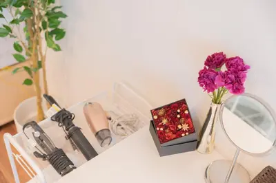 a table with a vase of purple flowers and a mirror at New Design Apartment in Shinjuku Kabukicho! 3 mins station in Tokyo