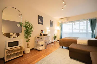 a hotel room with a bed and a mirror at New Design Apartment in Shinjuku Kabukicho! 3 mins station in Tokyo