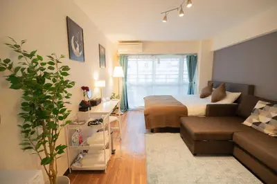 a living room with a bed and a couch at New Design Apartment in Shinjuku Kabukicho! 3 mins station in Tokyo