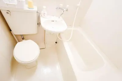 a white bathroom with a toilet and a sink at Near Shinjuku!Nishi Shinjuku Gochome 6min!\u897f\u65b0\u5bbf!\u5730\u94c1\u7ad9\u6b65\u884c6\u5206!\u65b0\u5bbf\u5f92\u6b65\u5708!\u7cbe\u81f4\u516c\u5bd3! \u9ad8\u901f\u65e0\u9650\u5236WIFI 203 in Tokyo