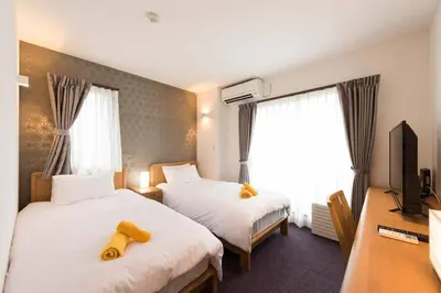 a hotel room with two beds and a television at Serorin Light Hotel Tokyo - Vacation STAY 46425v in Tokyo