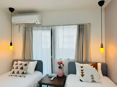a living room with two beds and a window at Shinjuku-Kabukicho-SJ0012 in Tokyo