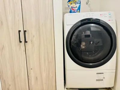 a washing machine sitting next to a wooden cabinet at Shinjuku-Kabukicho-SJ0012 in Tokyo