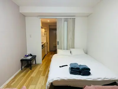 a bedroom with a bed with towels on it at Shinjuku-Kabukicho-SJ0012 in Tokyo