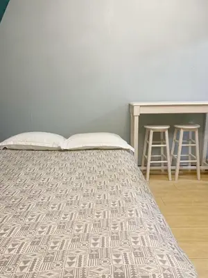 a bed in a room with a table and stool at Shinjuku Area!Nishi-Shinjuku Gochome subway 6 minutes walk! \u897f\u65b0\u5bbf\u4e94\u4e01\u76ee\u8f66\u7ad9\u6b65\u884c6\u5206\u949f! \u9ad8\u901f\u65e0\u9650\u5236WIFI 201 in Tokyo