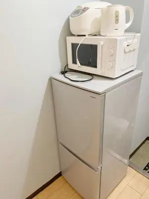 a microwave sitting on top of a refrigerator at Shinjuku Area!Nishi-Shinjuku Gochome subway 6 minutes walk! \u897f\u65b0\u5bbf\u4e94\u4e01\u76ee\u8f66\u7ad9\u6b65\u884c6\u5206\u949f! \u9ad8\u901f\u65e0\u9650\u5236WIFI 201 in Tokyo