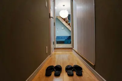 a pair of black shoes on the floor of a hallway at \u5929\u7a7a\u6811\u8fd1\u5728\u54ab\u5c3a! \u6d45\u8349\u79cb\u53f6\u539f\u5708\u5185! \u6700\u8fd1\u5730\u94c1\u6b65\u884c3\u5206\u949f! Near Skytree Asakusa!station 3 mins walk !\u5e72\u6e7f\u5206\u79bb! \u667a\u80fd\u9a6c\u6876! \u9ad8\u901f\u65e0\u9650\u5236\u7f51\u8def! 3LDK! Skytree in Tokyo