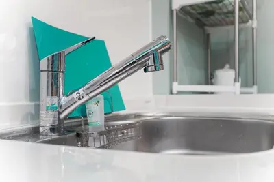 a kitchen sink with a faucet and a mirror at \u5929\u7a7a\u6811\u8fd1\u5728\u54ab\u5c3a! \u6d45\u8349\u79cb\u53f6\u539f\u5708\u5185! \u6700\u8fd1\u5730\u94c1\u6b65\u884c3\u5206\u949f! Near Skytree Asakusa!station 3 mins walk !\u5e72\u6e7f\u5206\u79bb! \u667a\u80fd\u9a6c\u6876! \u9ad8\u901f\u65e0\u9650\u5236\u7f51\u8def! 3LDK! Skytree in Tokyo