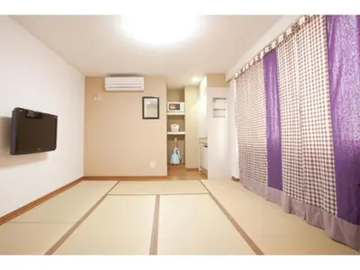 an empty room with a tv and purple curtains at Hotel Hanabi - Vacation STAY 67139v in Tokyo