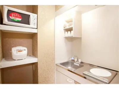 two pictures of a kitchen with a sink and a microwave at Hotel Hanabi - Vacation STAY 67133v in Tokyo