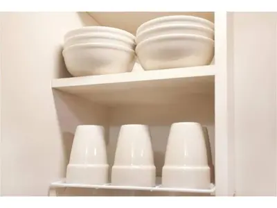 a cabinet filled with white bowls and plates at Hotel Hanabi - Vacation STAY 67133v in Tokyo